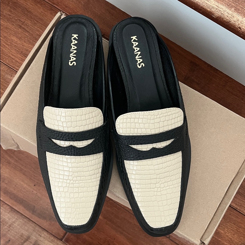 Kaanas Black and Cream Croc-Embossed Mules
Size 9 fits an 8